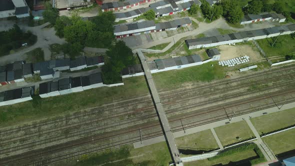 Flight Over Suburban Railway Station. Railroad Tracks And Sleepers Are Visible.