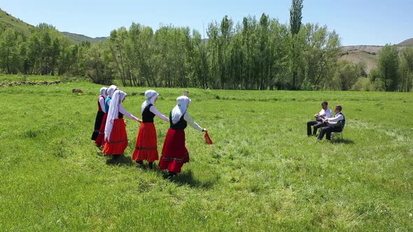 Young Women Traditionally Dancing In Traditional Clothes And Musicians In Village