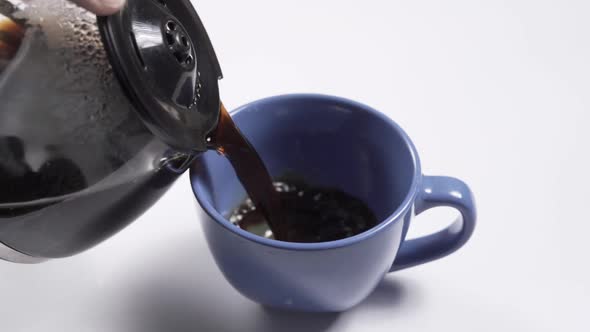 Pour Black Coffee Into a Mug From a Coffee Pot