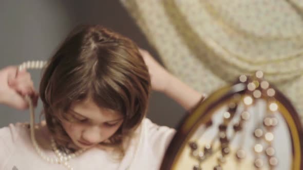 Daughter Putting on Mothers Jewelry, Pretending to Be Adult and Grown-Up