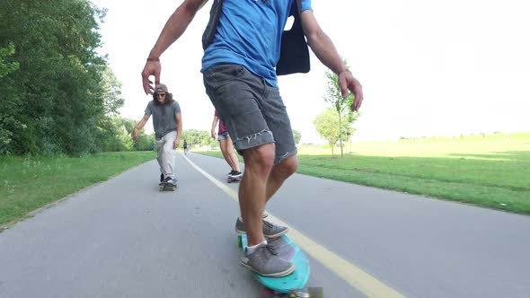 Close view of man longboarding with friends