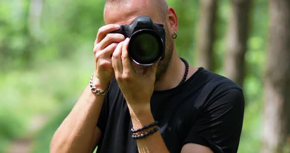 Male Photographer Take Photo with a Professional Camera Outdoor