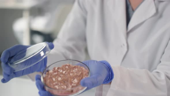 Asian Microbiologist With Lab-Grown Meat Sample