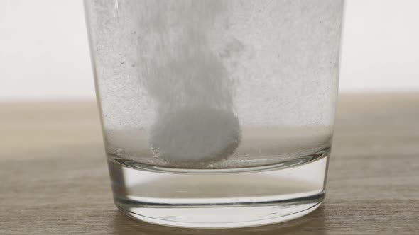 Effervescent Dissolving Fizzy Tablet in Water Glass