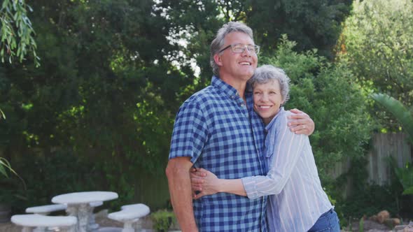 Senior couple embracing each other in the garden