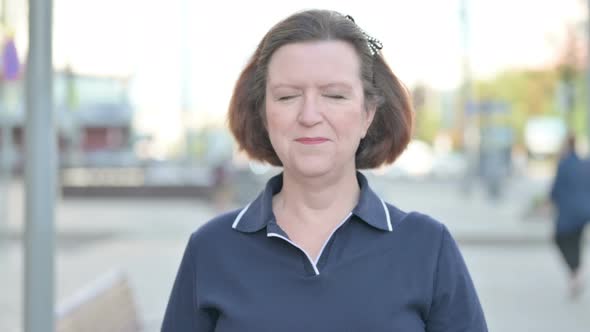 Portrait of Agree Old Woman Shaking Head in Approval Outdoor