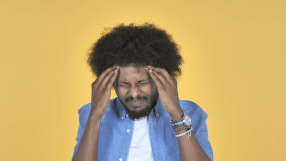 AfroAmerican Man with Headache on Yellow Background