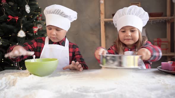 Brother and Sister Cooks Prepare Dough for Cookies From Flour