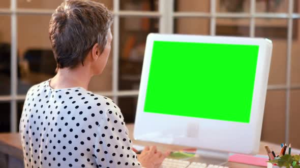 Casual Businesswoman Using Computer with Green Screen