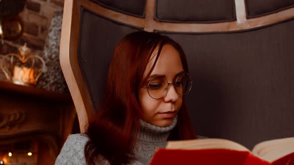 Young Woman in Glasses Reading Book