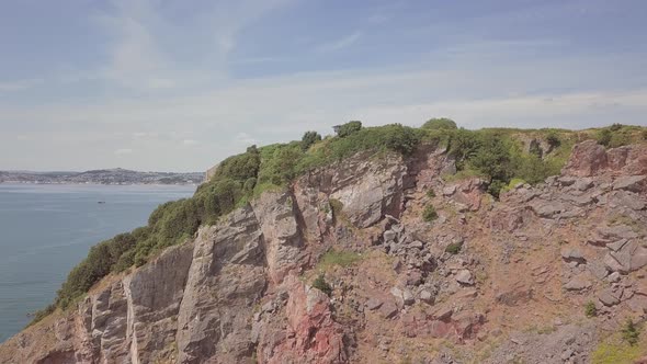 Aerial Dolly out of a cliffside near Torquay, South West England