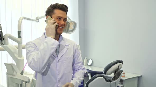 Dentist Uses His Cellphone at the Office