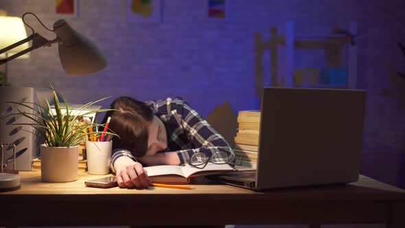 Overworked and Tired Businesswoman Sleeping at Her Laptop