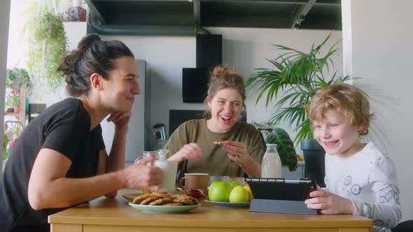 LGBTQ Family Using Digital Tablet on Breakfast