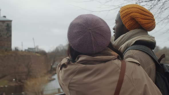 Young Tourist Couple Standing on Street and Discussing Town