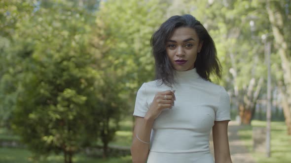 Playful Charming Black Female Flirting During Walk