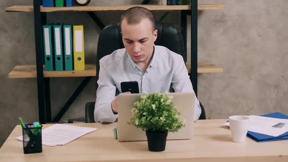 Young Man Doing Paperwork in Office