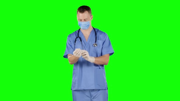 Man Take Off and Puts on His Surgical Gloves. Green Screen