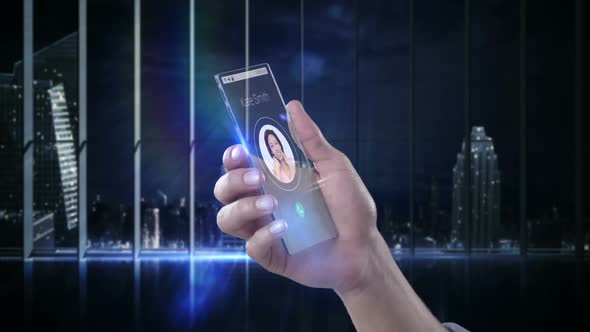 Hand holding futuristic mobile phone against digitally generated background