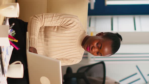 Portrait of African Woman Typing on Laptop Looking at Camera Smiling