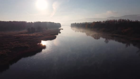 Aerial view of river channels with creeping morning fog.