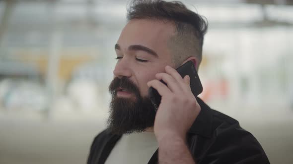 Calm Bearded Man Talking on Phone