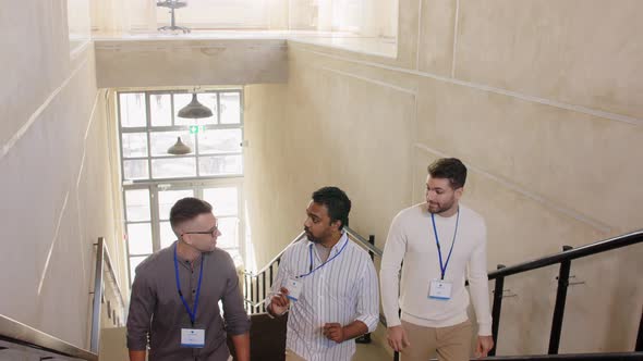 Businessmen with Name Tags Walking Upstairs