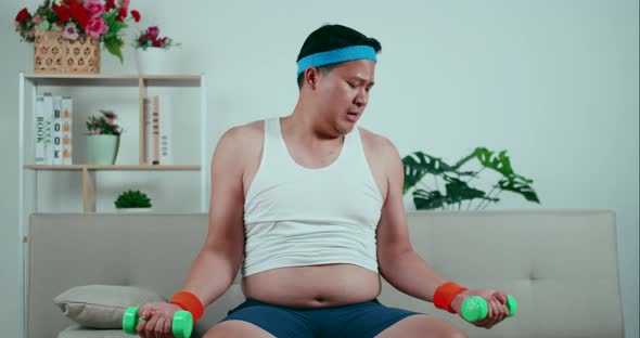 Overweight man with funny postures to exercise with dumbbells