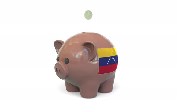 Putting Money Into Piggy Bank with Flag of Venezuela