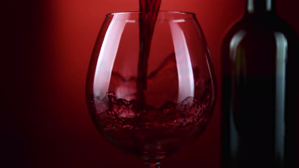 Super Slow Motion Shot of Pouring Red Wine From Bottle with Camera Rotation at 1000Fps