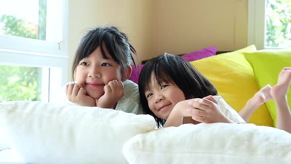 Cute Asian Children Playing On A Bed