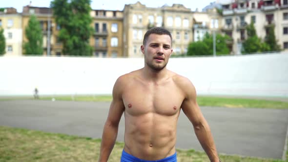 Muscular Guy with a Naked Torso in Outdoor Street Gym