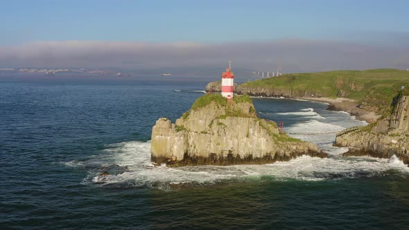 Basargin Lighthouse on a Rocky Island with a Suspension Bridge to It