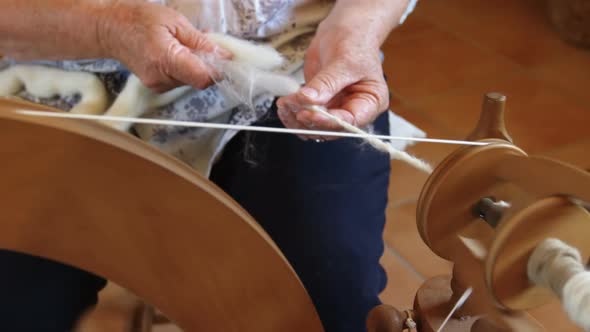 Senior woman operating weaving machine