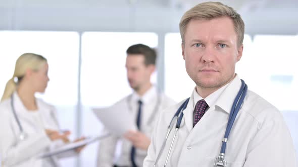 Portrait of Male Doctor Turning and Looking at the Camera