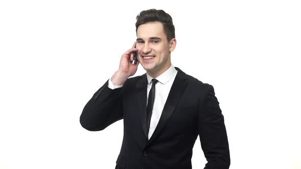 Successful Businessman Talking and Smiling on His Cell Phone. Close-up of a Handsome Young Business