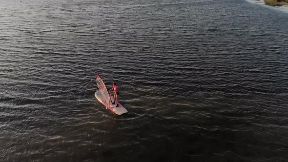 Aerial View of a Sportive Young Woman Learning To Fly a Windsurf Board