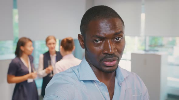 Close Up Portrait of African Businessman Looking at Camera Having Video Call at Office Party