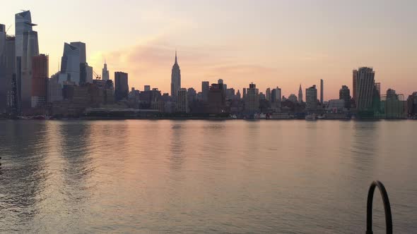 A take off shot from a concrete pier viewing Manhattan's westside in the morning. The camera dolly i