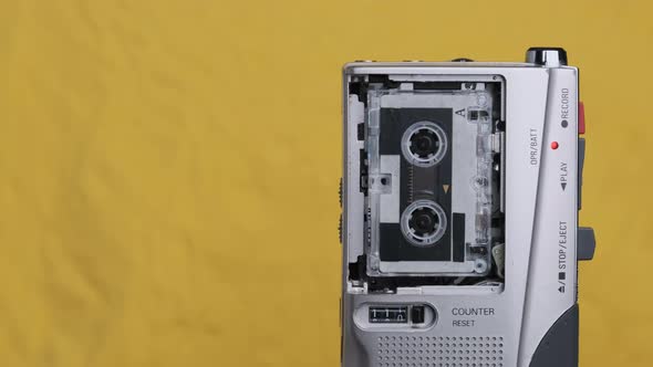 Portable Retro Tape Recorder with Micro Cassette Rec Sound on Yellow Background