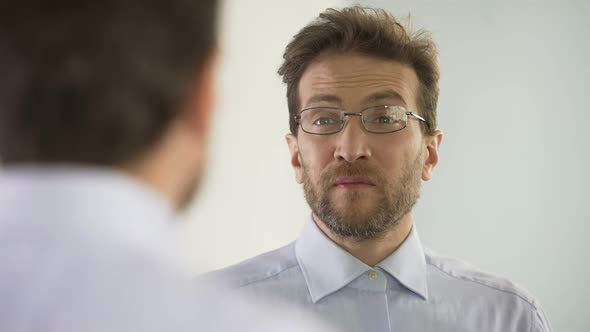 Man Dissatisfied With His Glasses and Thinking About Vision Correction Procedure