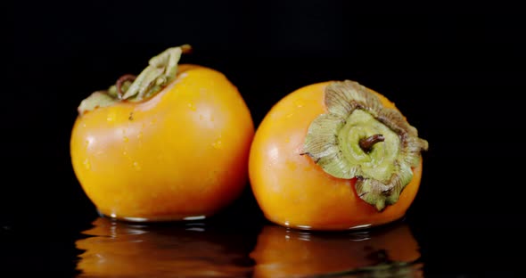 Fresh Persimmon Falls To the Water with a Splash. 