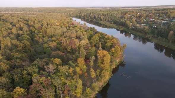 Aerial View of Woodland and Calm River at Sunset