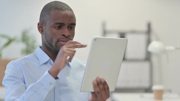 African Man Using Tablet Browsing Internet