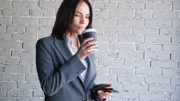 Smiling Businesswoman with Short Hair Types on Smartphone