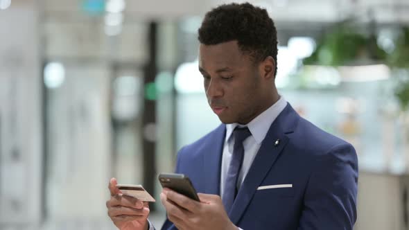 Online Shopping Payment Success on Smartphone By African Businessman