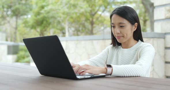 Woman use of notebook computer at outdoor