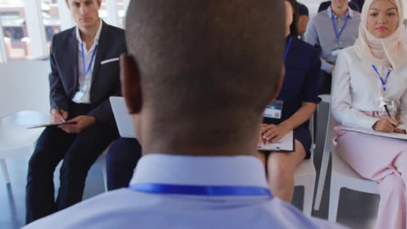 Male speaker addressing the audience at a business seminar