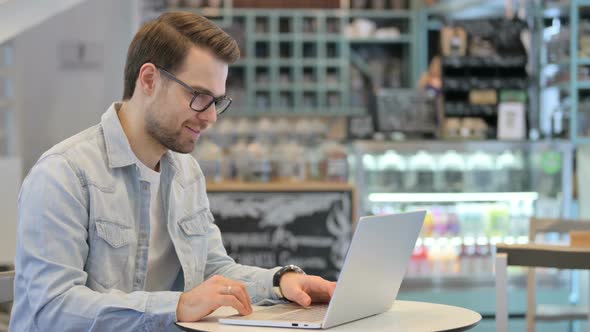 Man Talking on Video Call on Laptop