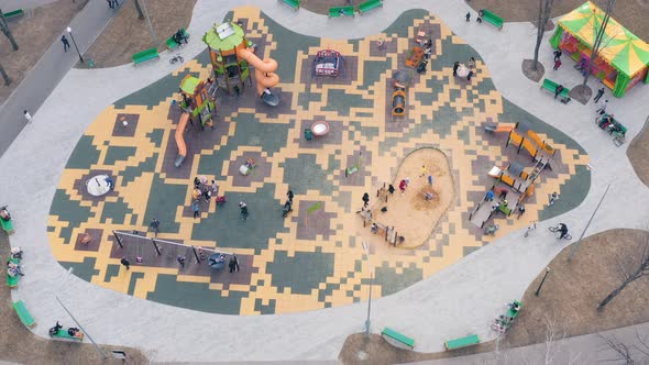Children Play on the Playground with Swings Carousels and Roller Coasters  Aerial View